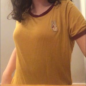 yellow shirt with red trim